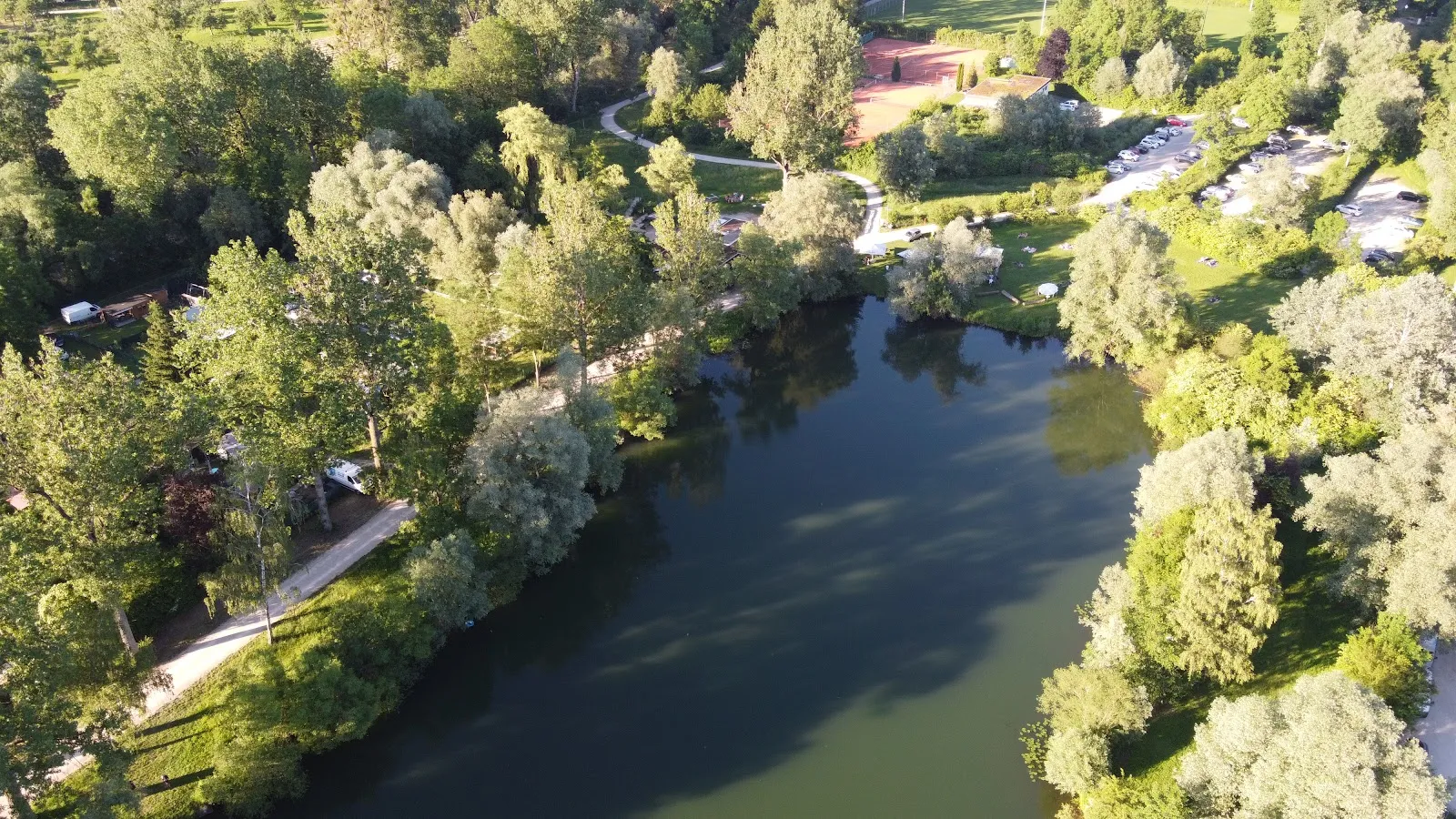 Вид на озеро Бойтванг в Нюртингене, Германия, с зелеными берегами и чистой водой.