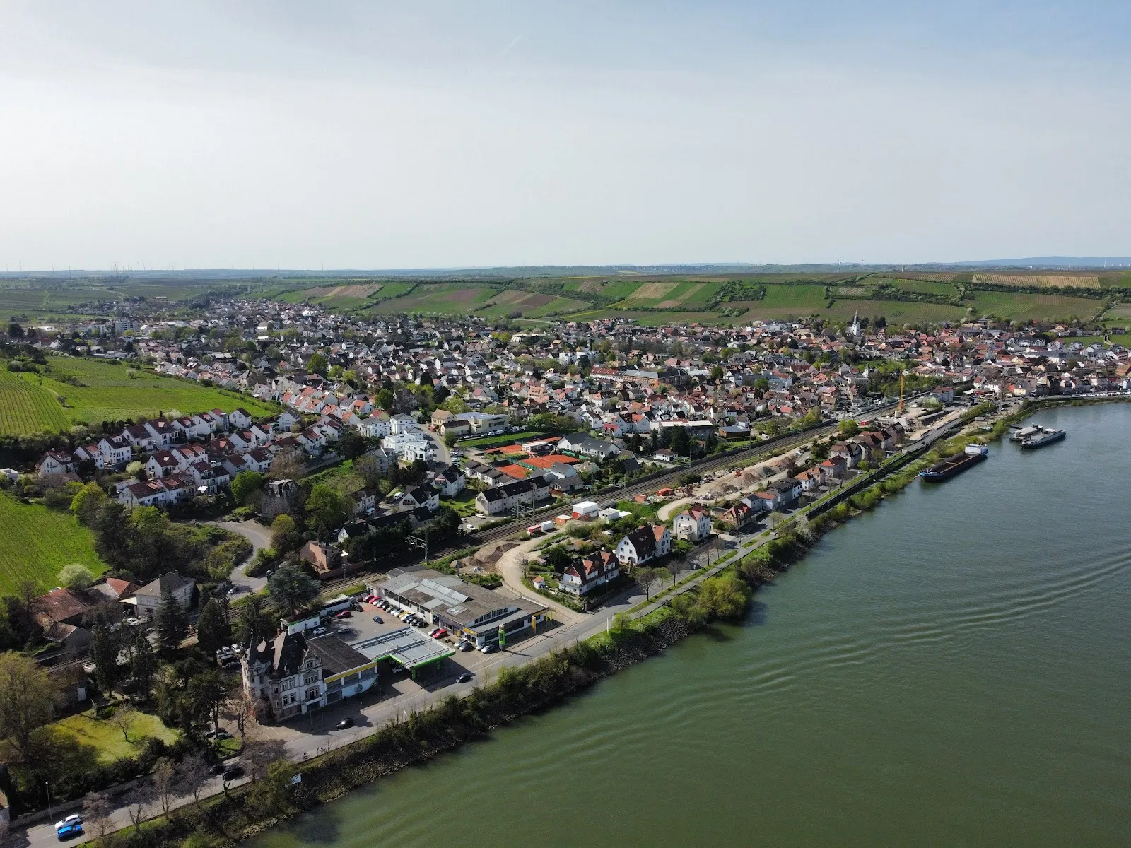 Вид на набережную Рейна в Нирштайне, Германия, с мостом и водой.